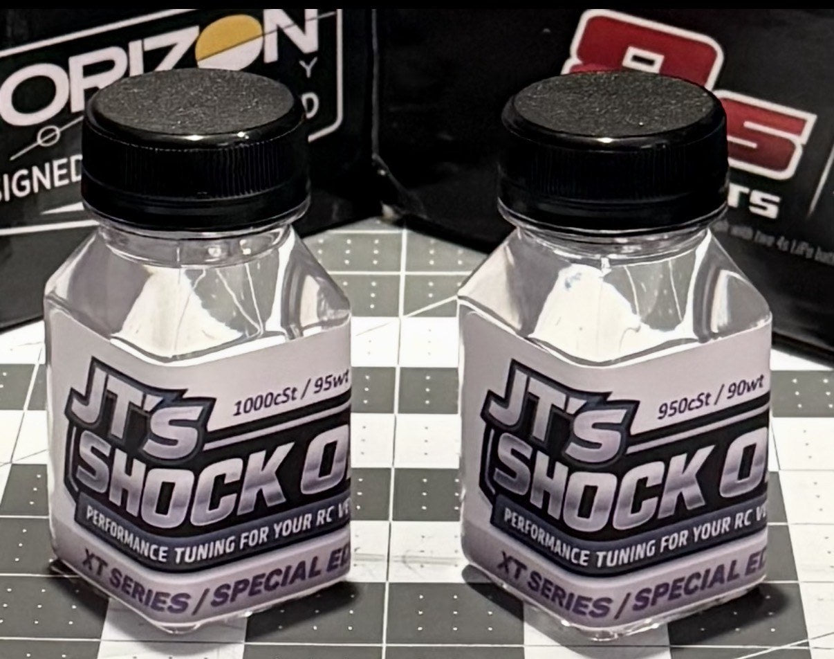 Two bottles of JT's Shock Oil XT Series on a cutting mat